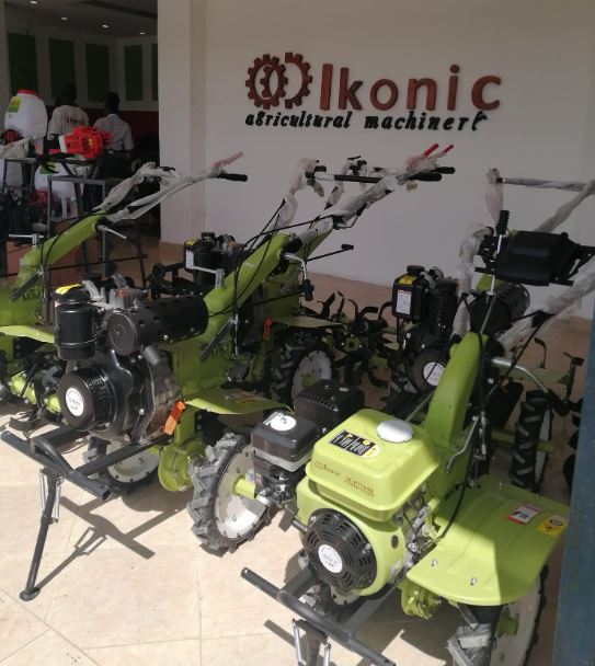 A Green Hand Tractor inside a Store with Branding Ikonic Machinery