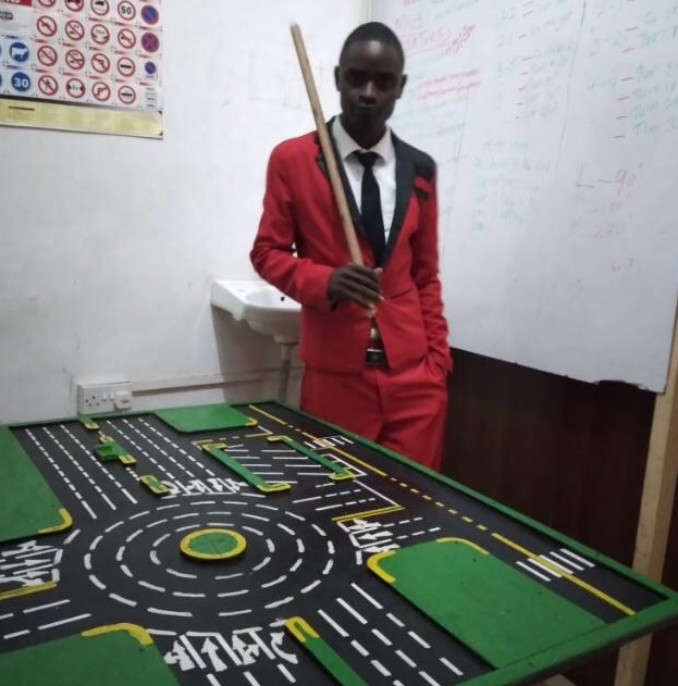 A Teaching Driving Instructor In front of a Driving Table
