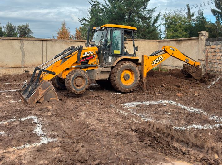 a backhoe on site digging