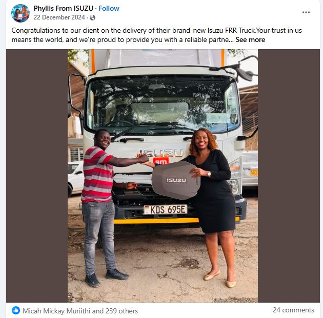 Phyllis from Isuzu gifts a customer an Isuzu Big Key