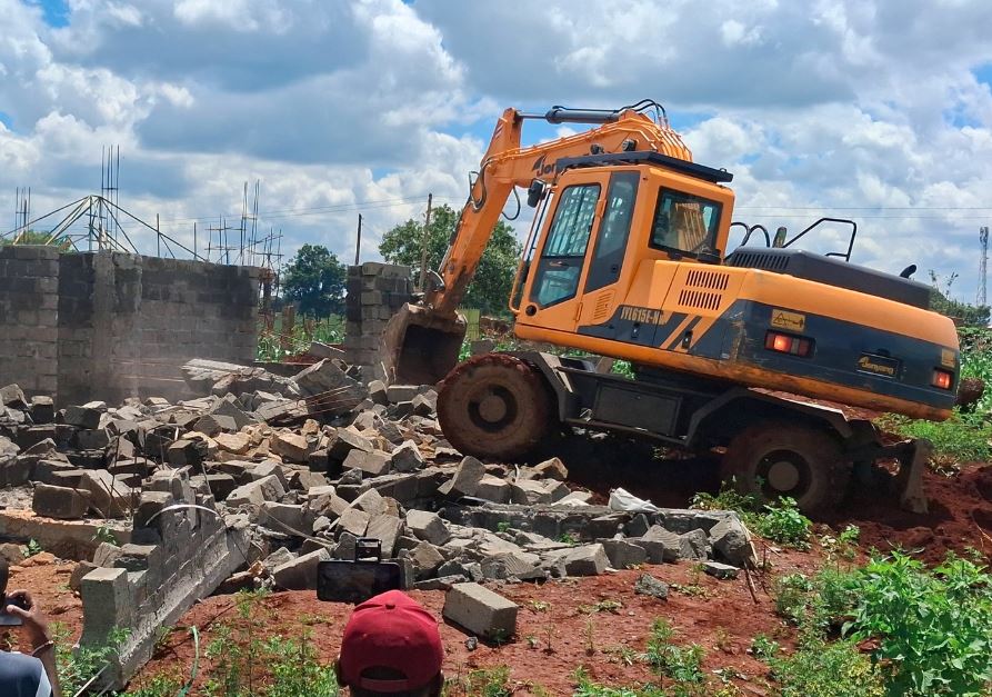 A mini excavator at work demolishing